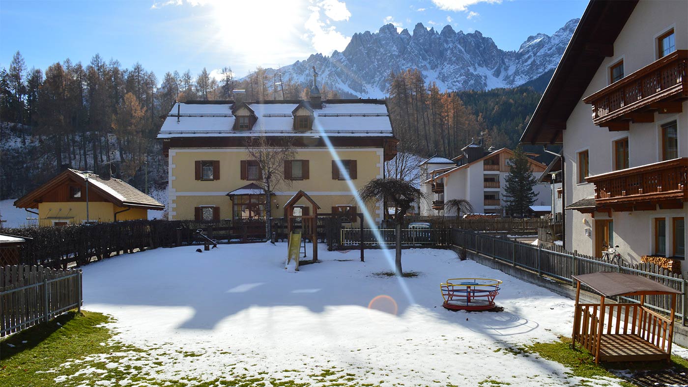 The snow-covered children's playground in the garden of Edelweiss in winter